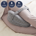 Gray side-sleeper knee pillow strapped between the knees in bed, with 30-night guarantee, washable cover and free US shipping badges