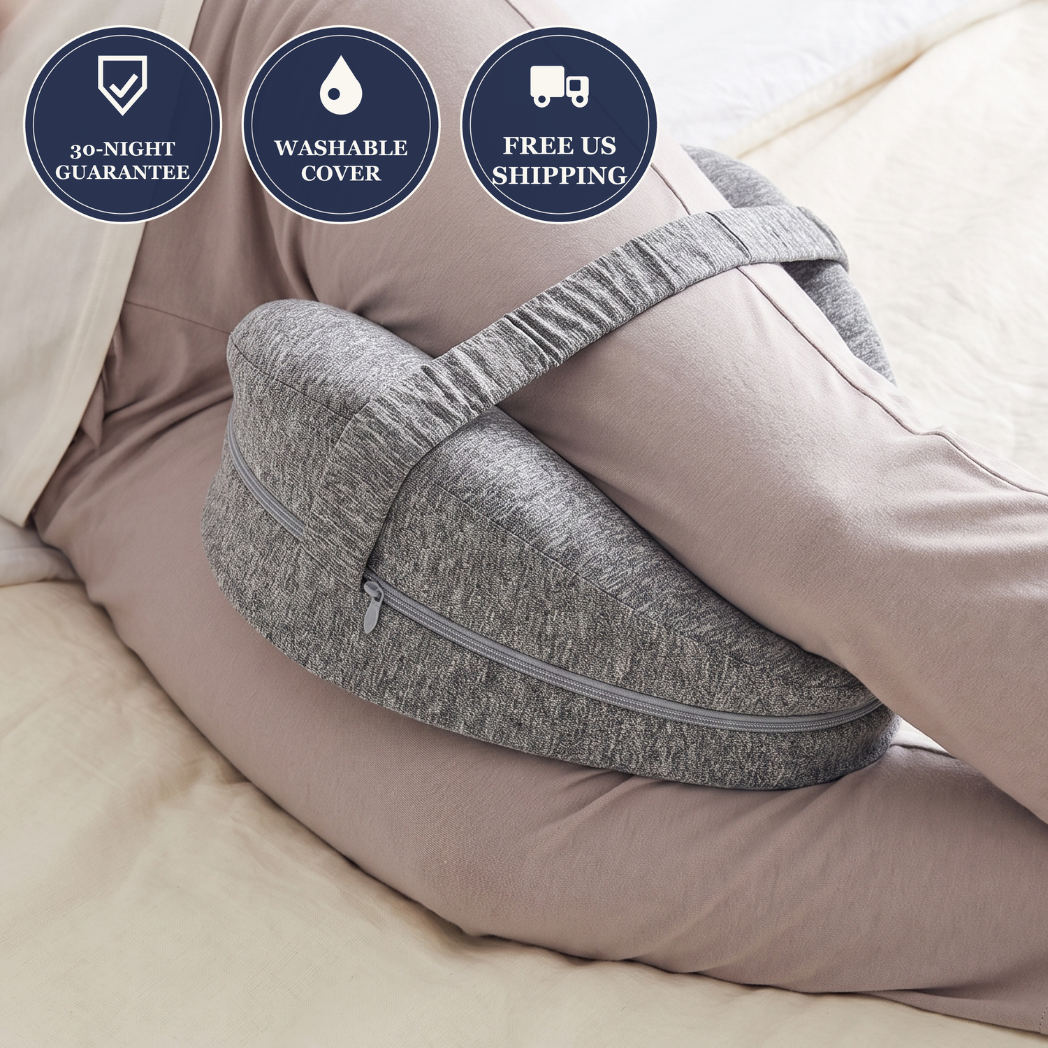 Gray side-sleeper knee pillow strapped between the knees in bed, with 30-night guarantee, washable cover and free US shipping badges