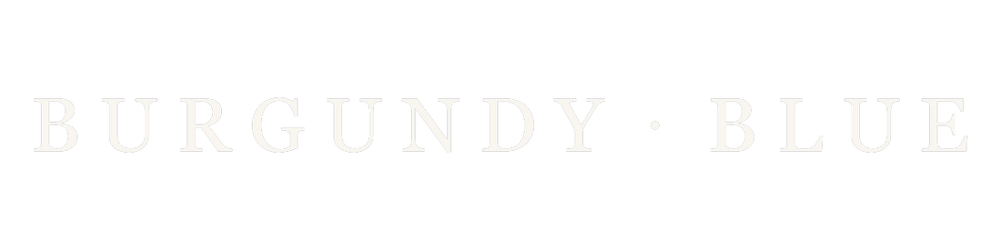 Burgundy Blue wordmark logo, cream lettering on transparent