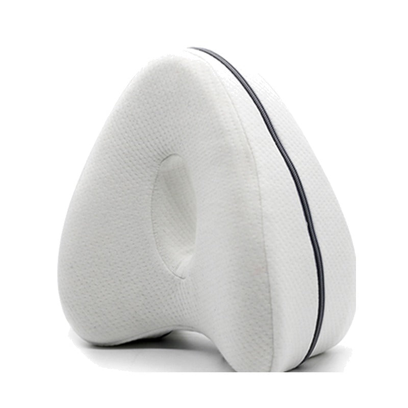 White side-sleeper knee pillow with hollow center and zipper on a white background